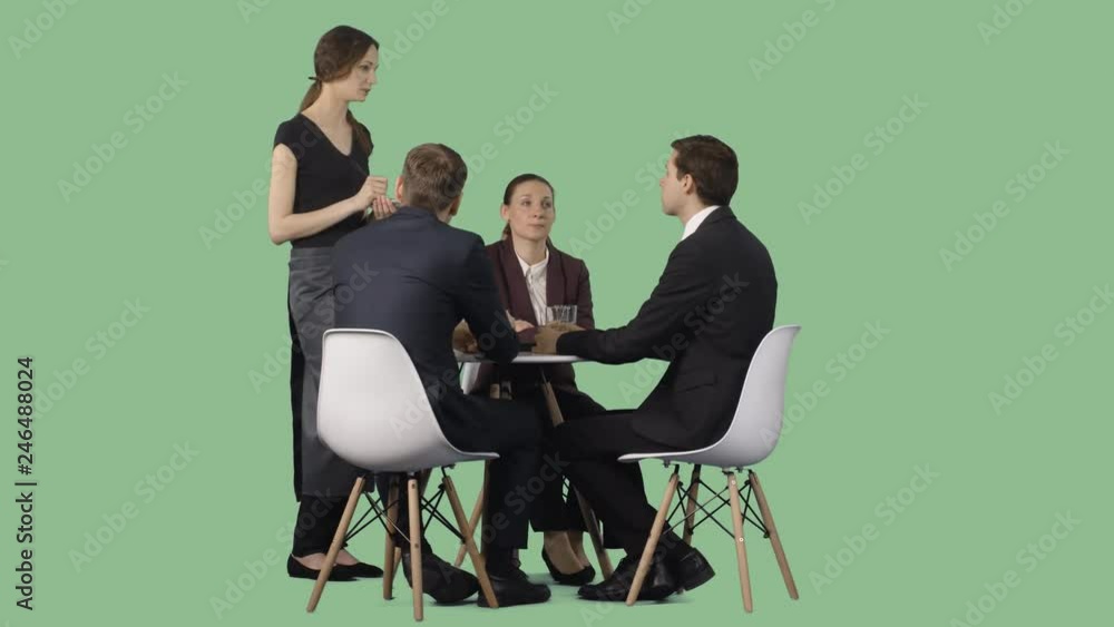 Three people in a business clothes make an order to the waiter in a cafe. Green screen Three people in a business clothes make an order to the waiter in a cafe. Green screen