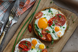 Toast with fried egg and tomatoes, close view