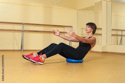 Sport woman doing abs exercise in gym