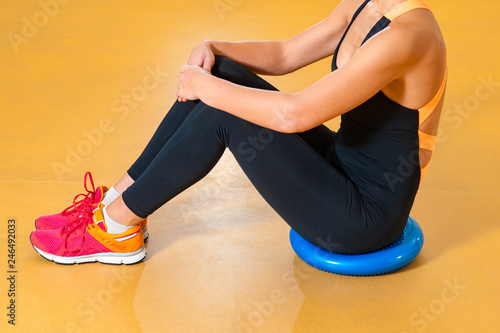 Sports girl sitting on floor while resting