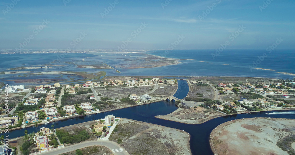 Aerial photo of buildings, villas and the beach on a natural spit of La Manga between the Mediterranean and the Mar Menor, Cartagena, Costa Blanca, Spain