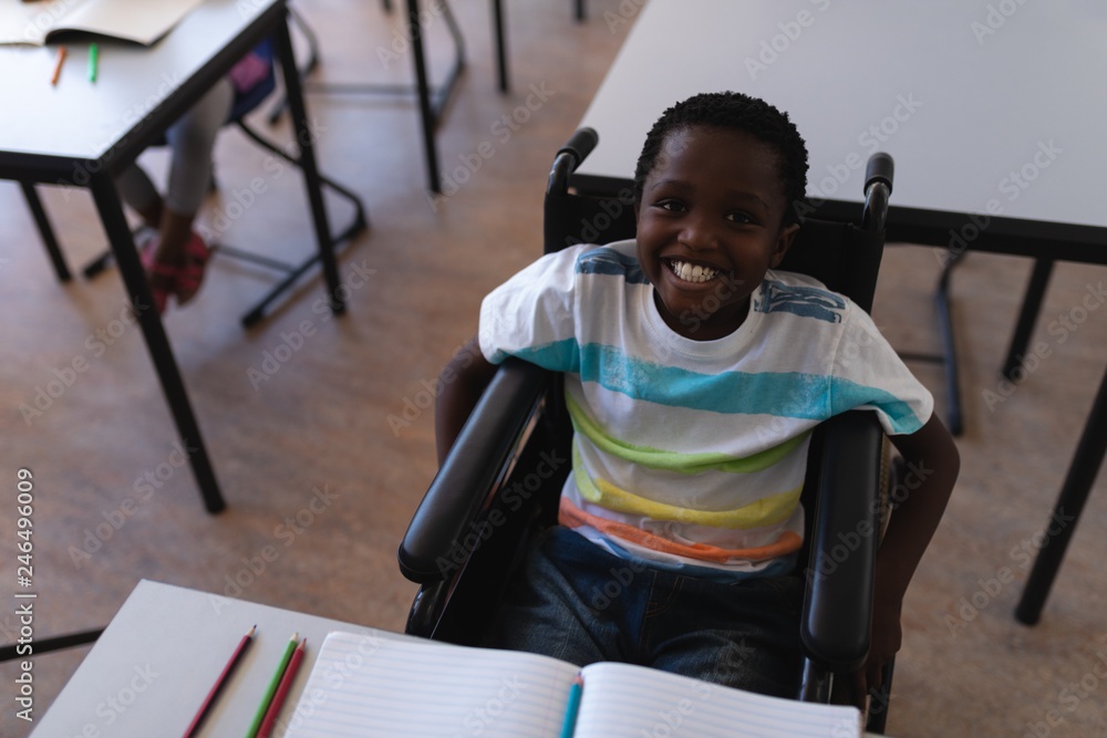 Disable schoolboy looking at camera in classroom Disable schoolboy looking at camera in classroom