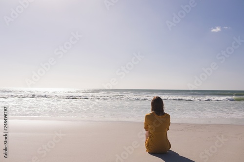 Woman relaxing and looking at view on the beach