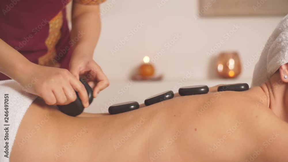 Back massage helping relieve muscle tension and pain. Reducing muscle spasms and increase flexibility