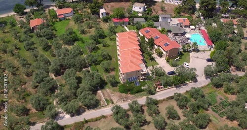 Aerial reverse pan up reveal from Hotel Zafira, Thassos, greece to reveal olive tree plantation photo