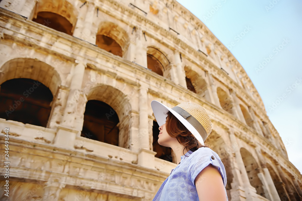 Young female traveler looking on famous the Colosseum in Rome.