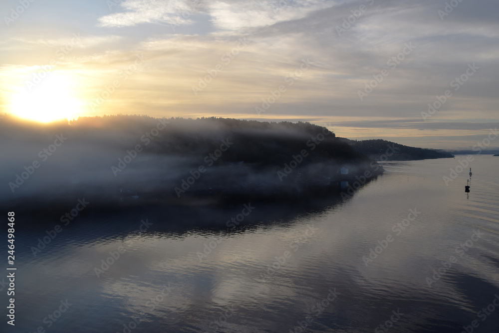 Sunrise and fog in the fjord. Photo taken just outside Oslo, Norway