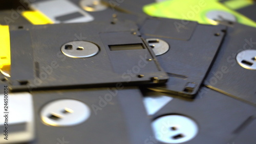 pile of old style data transfer floppy discs, rotating spinning background