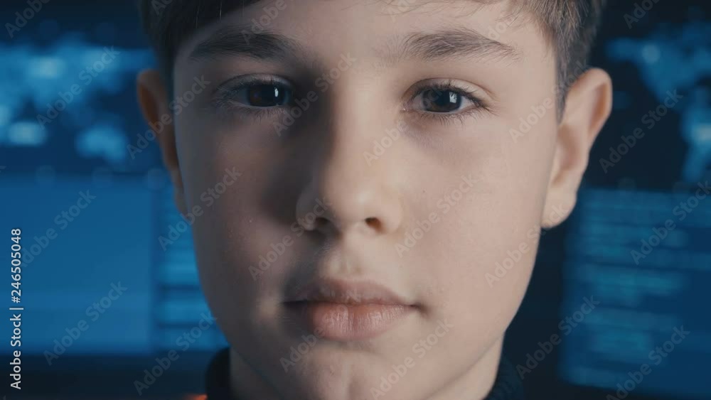 Close-up Prodigy Boy Hacker Programmer at data center filled with monitor screens Close-up Prodigy Boy Hacker Programmer at data center filled with monitor screens