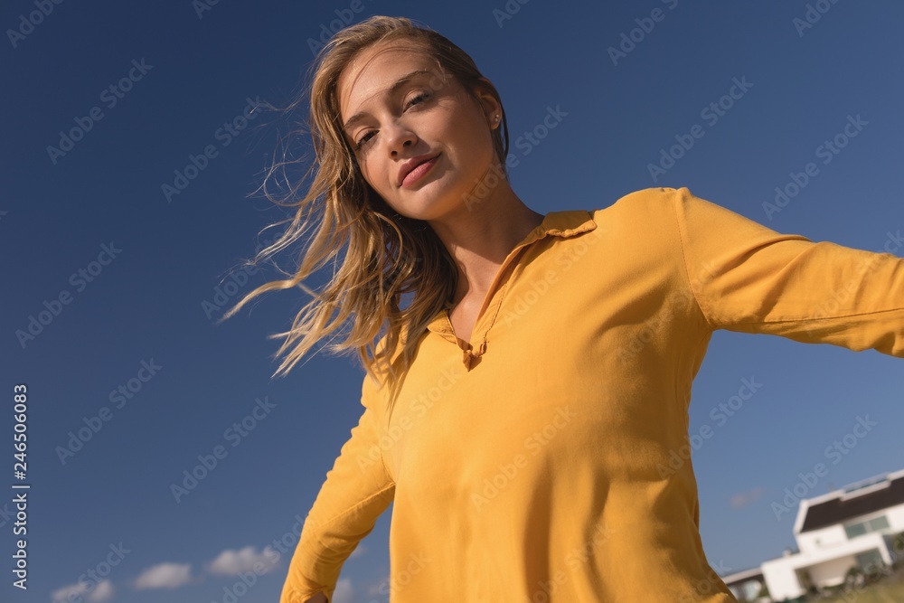 Woman standing with arms outstretched on the beach Woman standing with arms outstretched on the beach