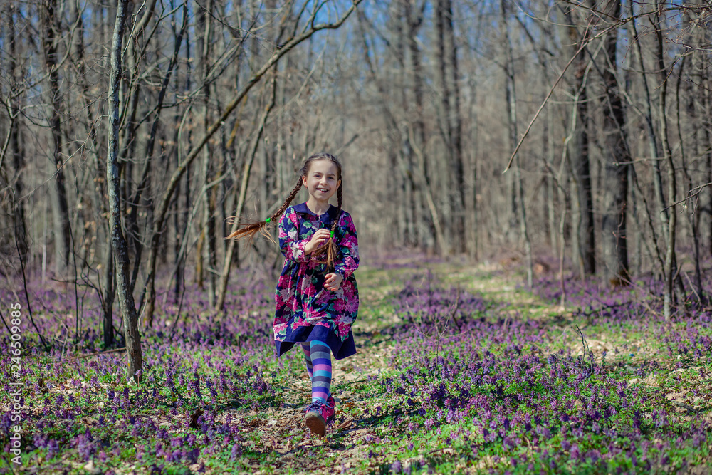 Portrait of a beautiful little girl with corydalis flowers. Portrait of a beautiful little girl with corydalis flowers.