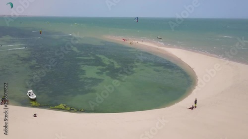 Drone footage of two people on the beach watching kitesurfers in Dakhla, Morocco