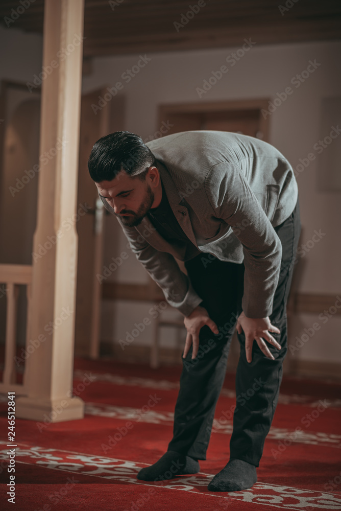 Muslim man praying in mosque Muslim man praying in mosque