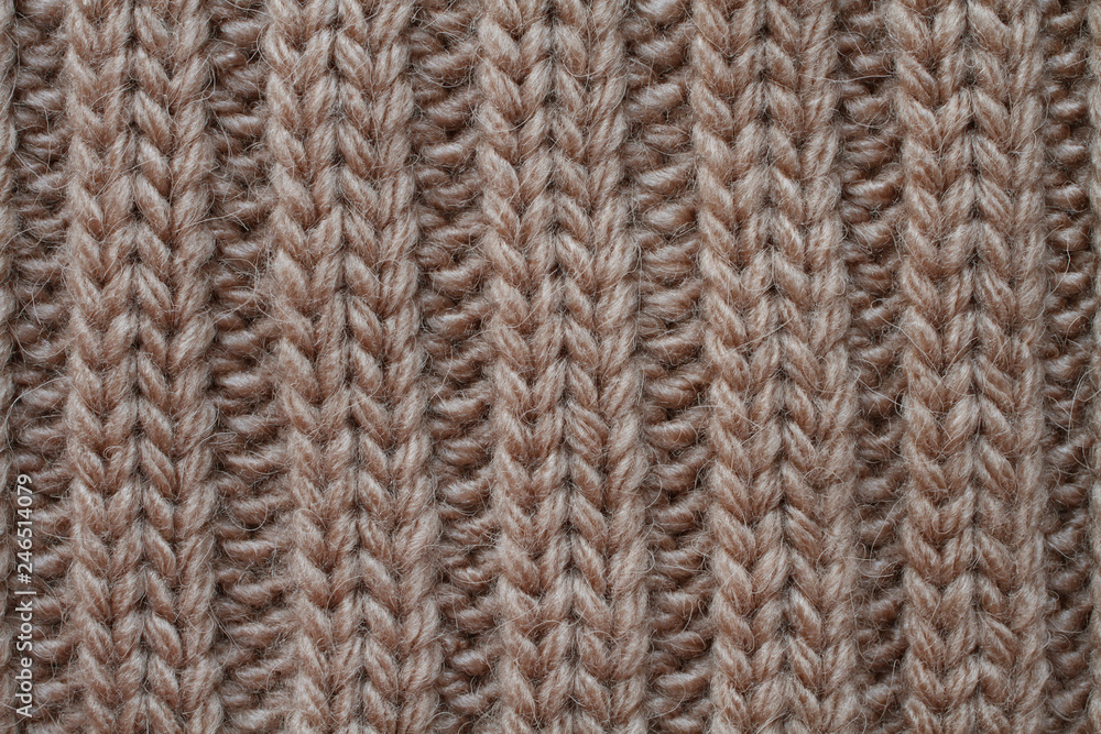 Light brown woolen knitted fabric texture. Macro. Light brown woolen knitted fabric texture. Macro.