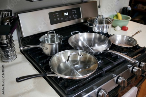 Modern stainless steel gas stove oven with stainless steel cookware.
