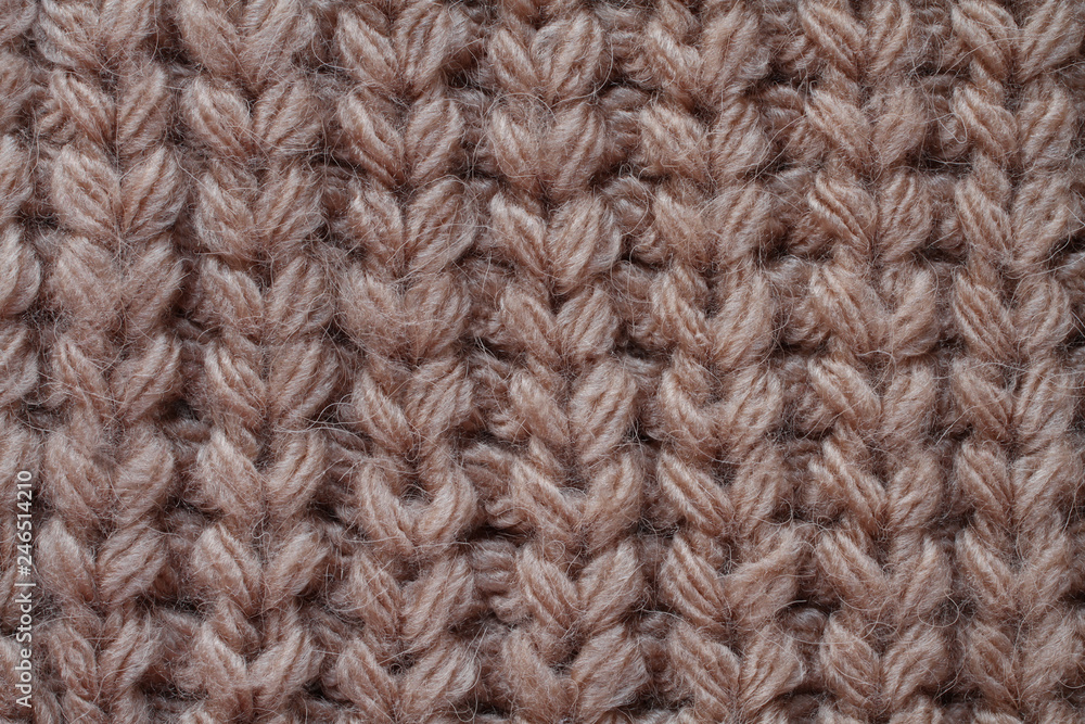 Light brown woolen knitted fabric texture. Macro.