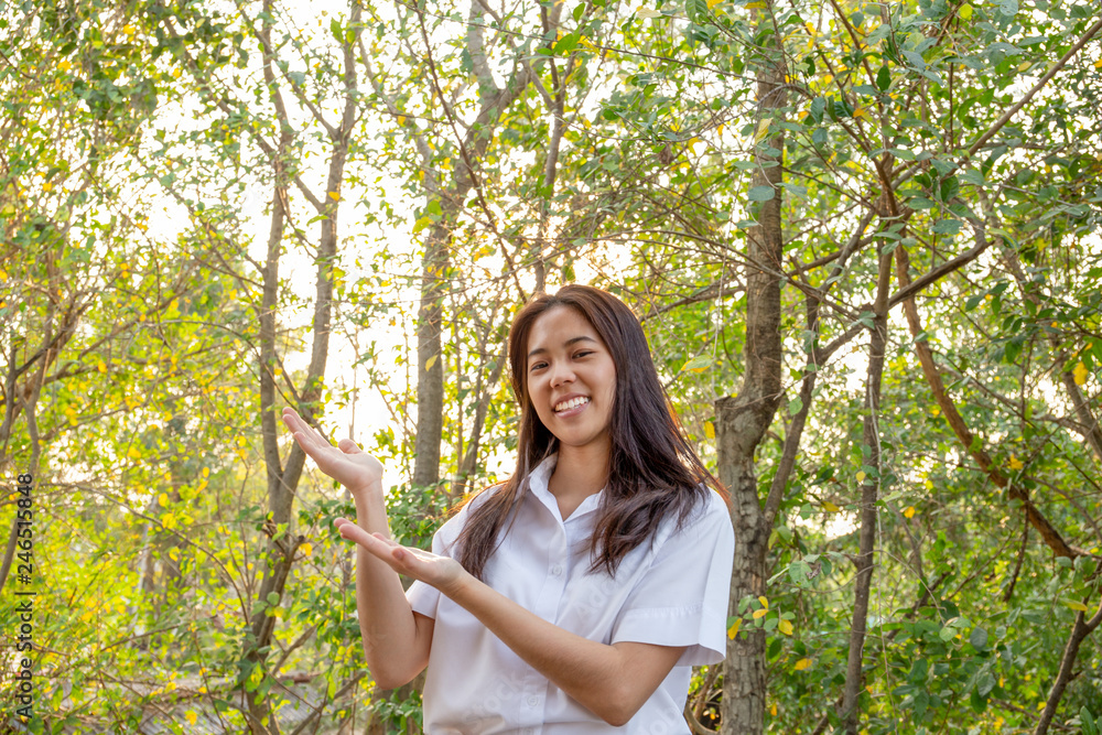 collage woman smiling showing her palm up forest backgroung environment concept. collage woman smiling showing her palm up forest backgroung environment concept.