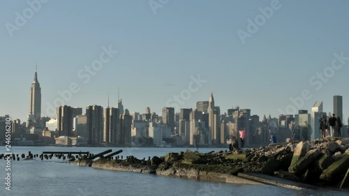 This is a Time Lapse of the New York City Time Lapse taken from the Eat River.  Tourists enjoy the view of the NYC Skyline by the Water. photo