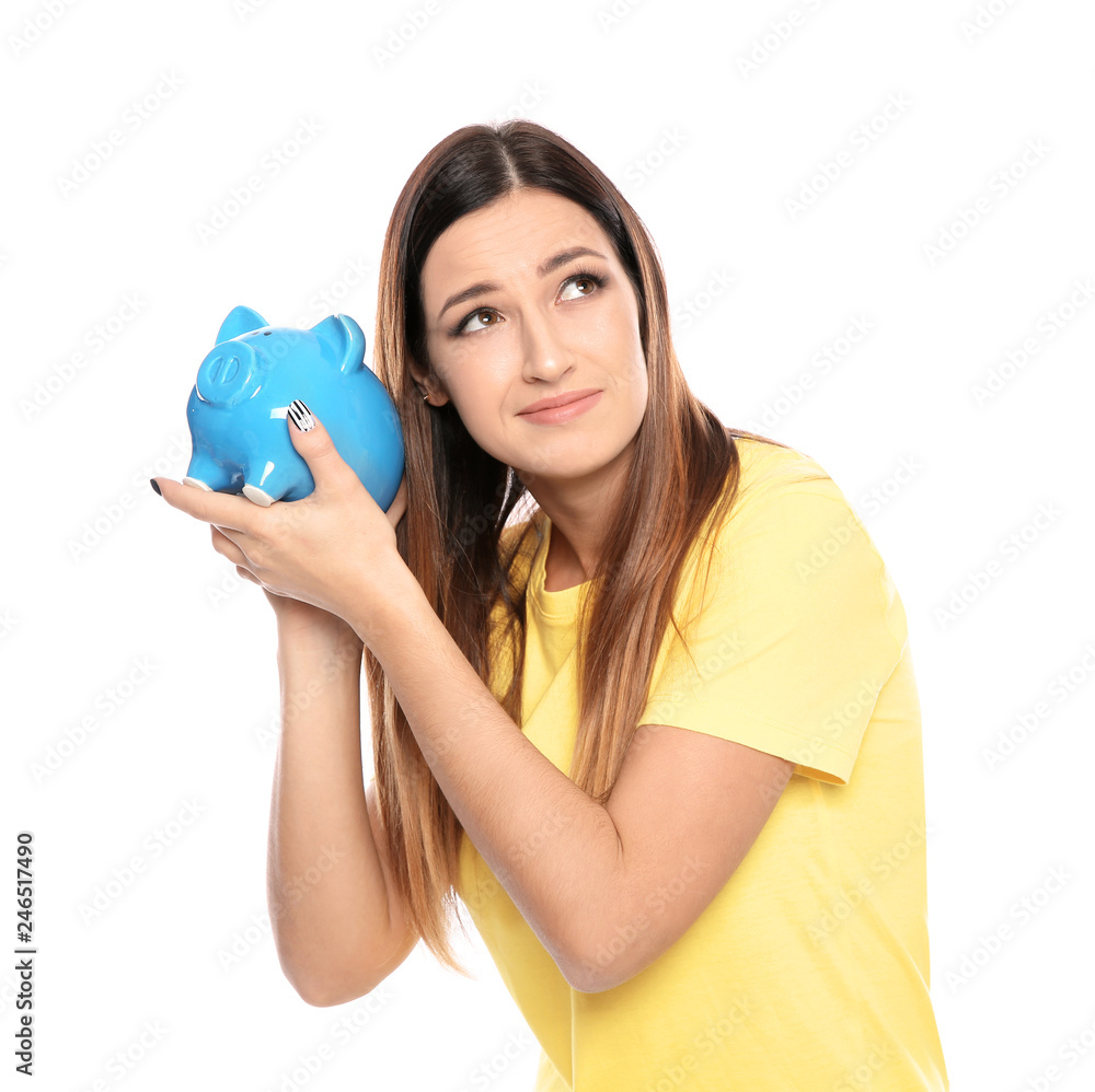 Young woman with piggy bank on white background Young woman with piggy bank on white background