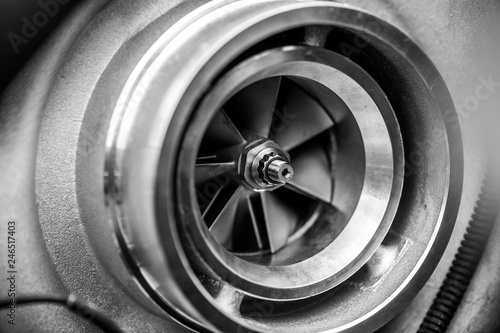 Close up detail of a diesel engine turbocharger with fan blades and center axle - selective focus on center axle photo