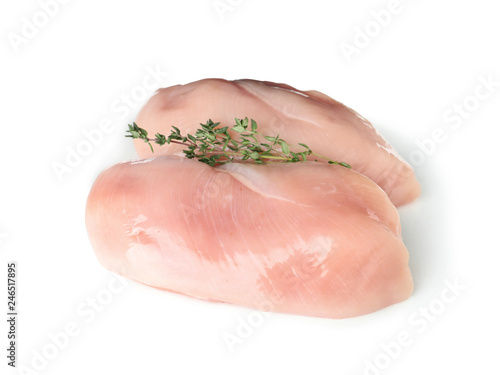 Raw chicken breasts with thyme on white background. Fresh meat