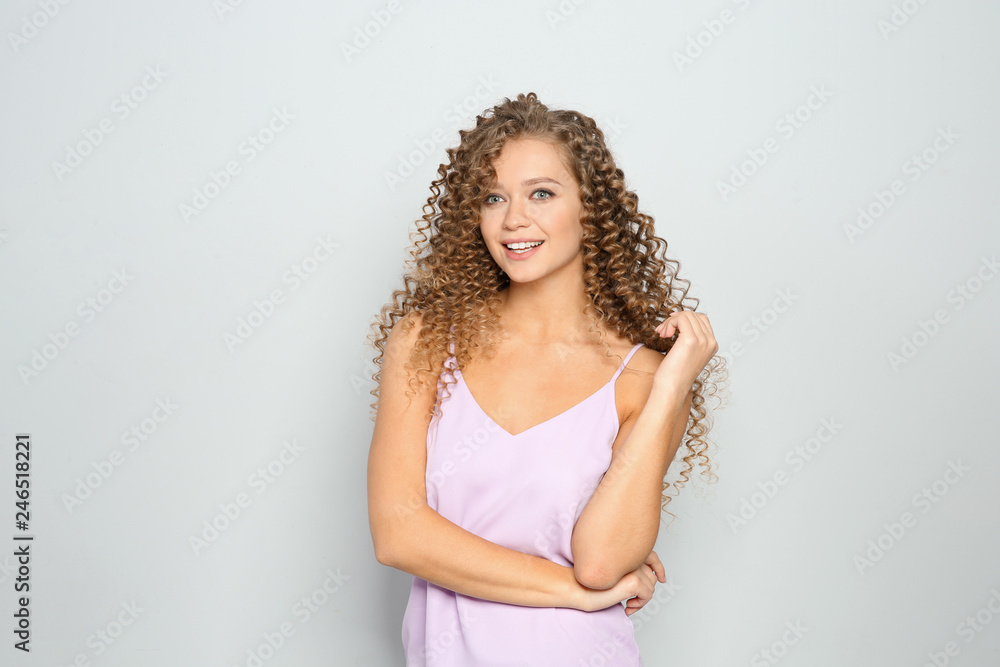 Portrait of beautiful young woman with shiny wavy hair on color background Portrait of beautiful young woman with shiny wavy hair on color background