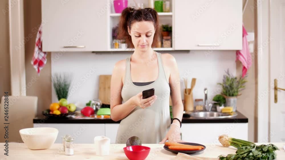 Woman reading online recipe for healthy meal on digital tablet Woman reading online recipe for healthy meal on digital tablet