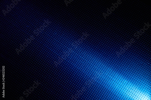 Diagonal bright beam of light on a blue background