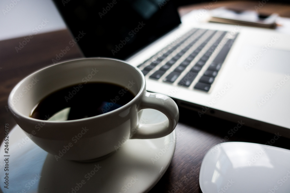 Close up office desk table with laptop, note book, mobile coffee and pen. Selective focus. Business concept. Copy space. Close up office desk table with laptop, note book, mobile coffee and pen. Selective focus. Business concept. Copy space.