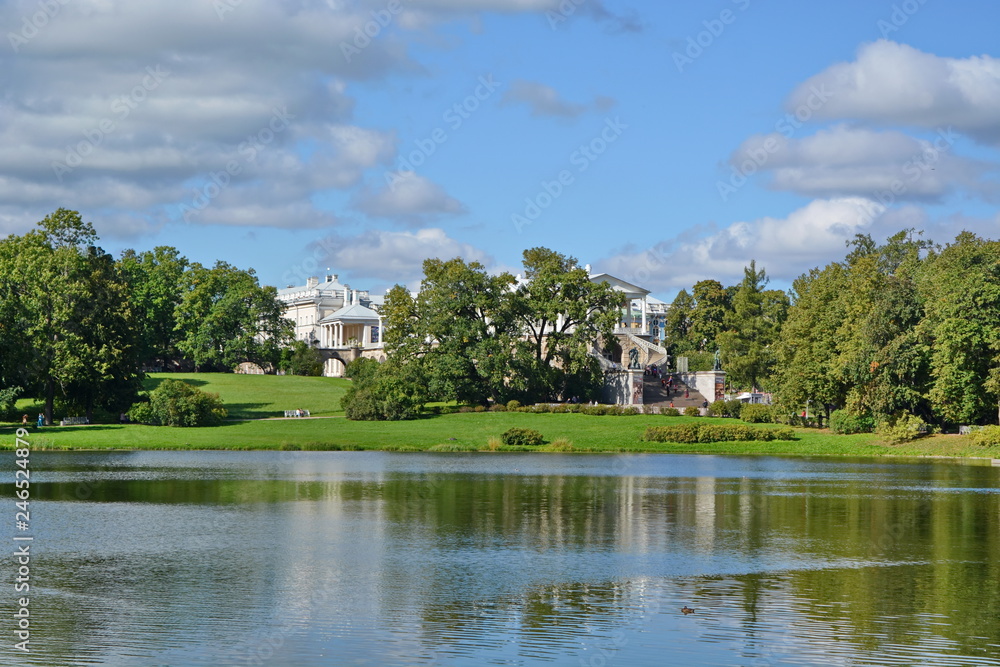 luxury palace with columns and statues on the hill on the coast of lake hidden among the trees luxury palace with columns and statues on the hill on the coast of lake hidden among the trees