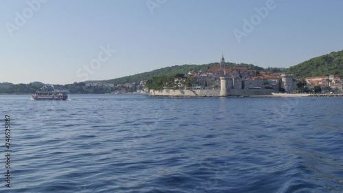 View of boat in Luka Korculanska Bay leaving Korcula Old Town, Korcula, Dalmatia, Croatia, Europe photo