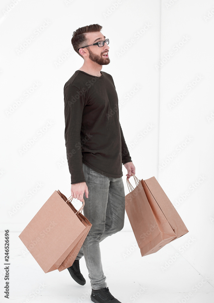Portrait of a man with a full paper bag on a gray Portrait of a man with a full paper bag on a gray
