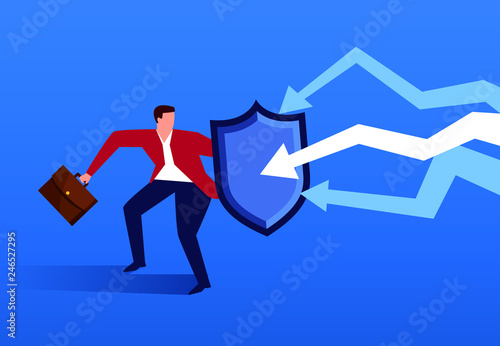 Businessman holding shield against falling arrow