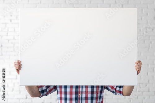 Holding canvas mockup. Photo Mockup. The man hold canvas. For canvas design. Frame size 36x24 (91x61cm). photo