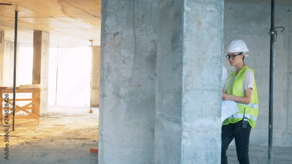 Constructors discussing a plan on a site, side view. Constructors discussing a plan on a site, side view.