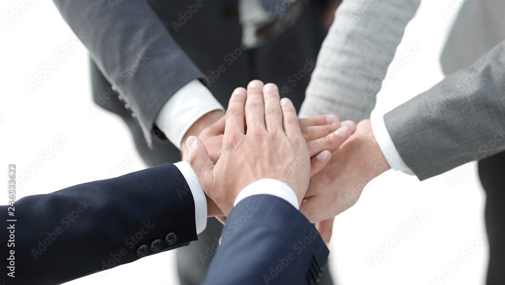 Top view of young people putting hands together Top view of young people putting hands together