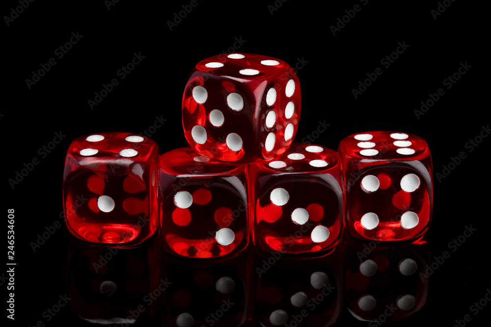 red transparent dice for gambling on a black background red transparent dice for gambling on a black background