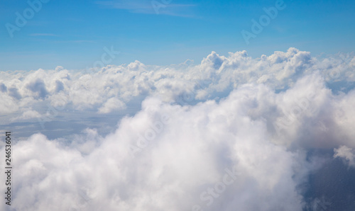 Blue sky with white cloud scenic photo. Cloudscape from airplane window. Skyscape abstraction. Optimistic sunny sky