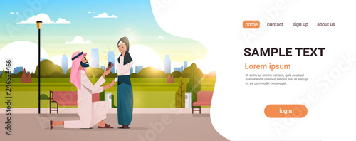 arab man kneeling holding engagement ring proposing woman marry him city park cityscape background couple in love marriage offer happy valentines day concept copy space