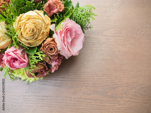 Bouquet of mixed flowers on wood background, Roses, Carnation, Eustoma, dry flowers. © Umaporn Y.