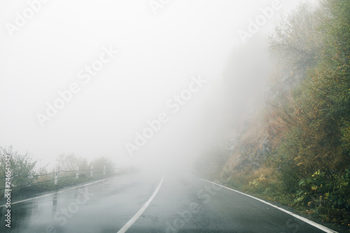 On a foggy road along nature with a limited view. Rood in fog.