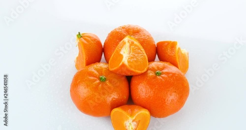 rotating fresh tangerines isolated on white background