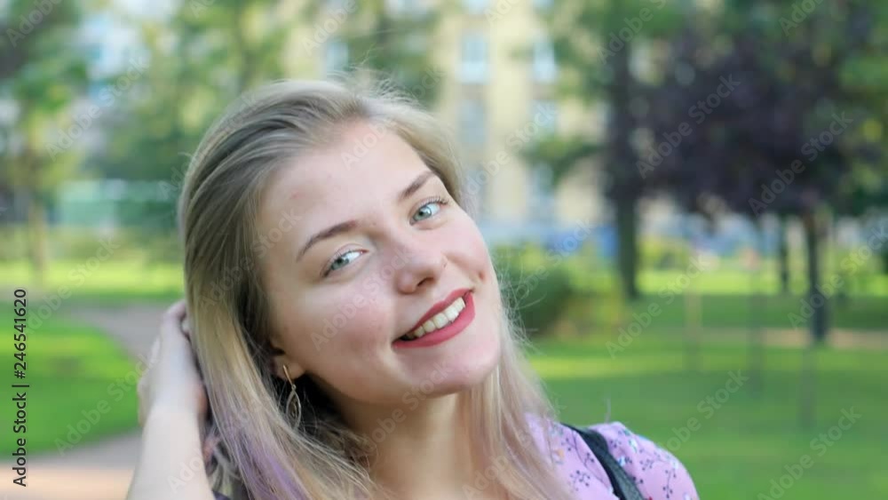 The girl is waiting for a meeting with her boyfriend. Summer day in the park. The girl is waiting for a meeting with her boyfriend. Summer day in the park.