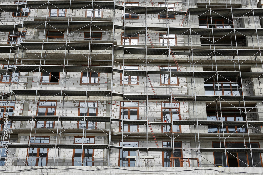 new building under construction, scaffolding and concrete new building under construction, scaffolding and concrete