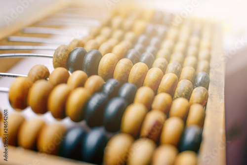 Close-up macro photo of vintage abacus for calculation.