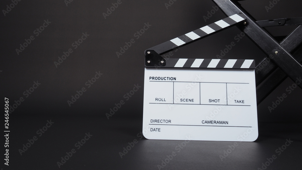 Clapperboard or clap board or movie slate with black director chair use in video production ,film, cinema industry on black background.