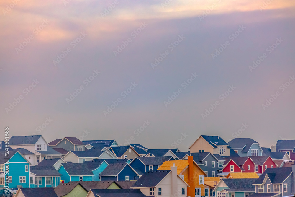 Colorful homes in Daybreak with sky in background