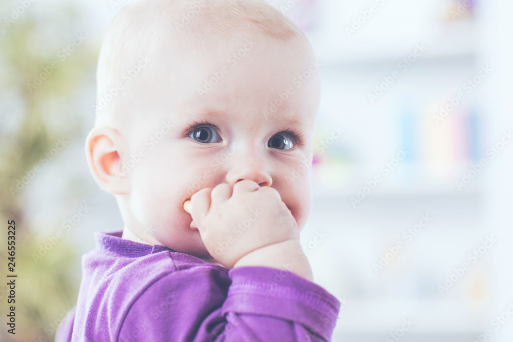 portrait of a happy one year old baby girl on a background of bright children's room portrait of a happy one year old baby girl on a background of bright children's room