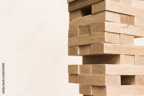 Board game jenga. Wooden blocks. A logic game for two and a company. Entertainment for adults and children. Useful leisure. Educational toys. Wooden bricks. Tower of cubes.