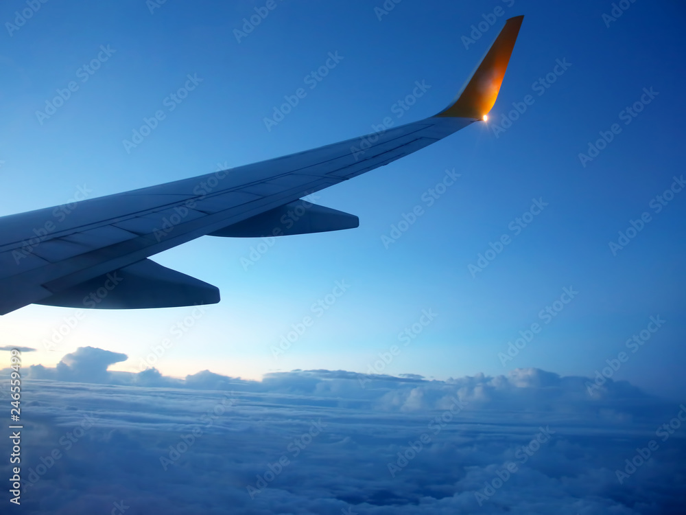 The wing of an airplane above the clouds The wing of an airplane above the clouds